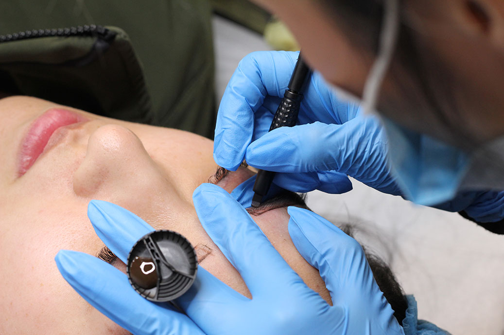 Inkspiration artist performing a brow service